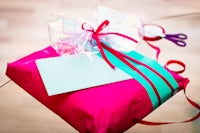 red and white gift box with white ribbon