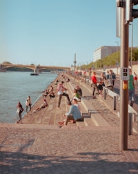 people sitting on brown wooden dock during daytime