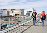 a couple of women walking on a sidewalk