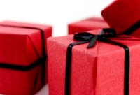 Three red gift boxes with a black ribbon