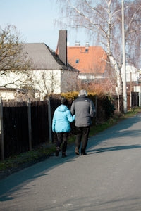 A man and a woman walking down a street