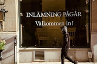 A person walks past a storefront window.