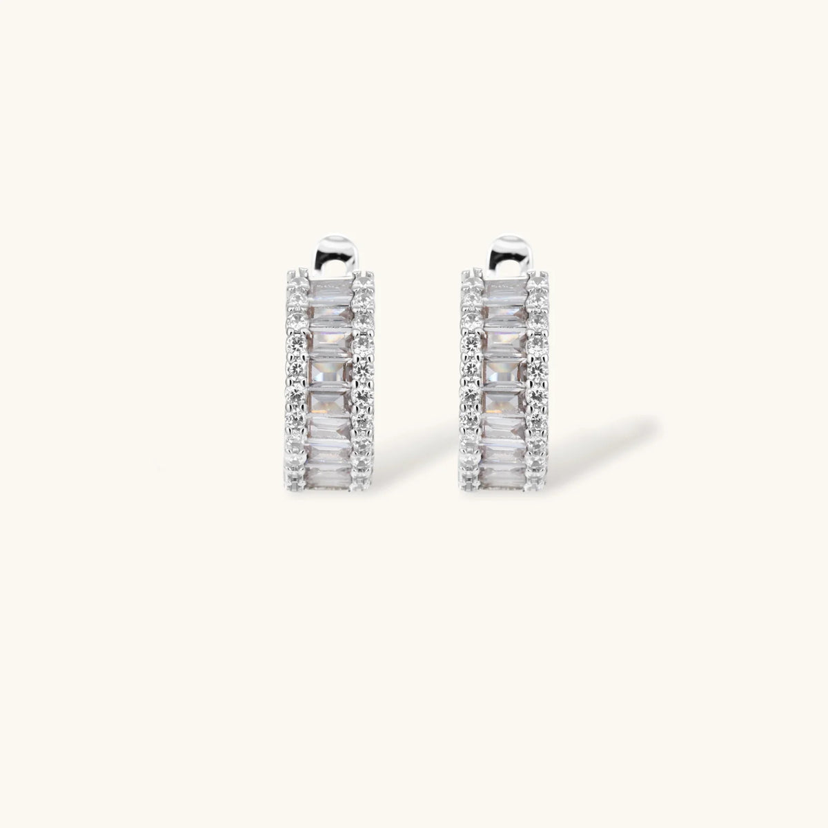 White gold plated necklace with vertical cubic zirconia pendant and matching hoop earrings on neutral background