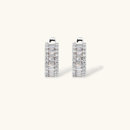 White gold plated necklace with vertical cubic zirconia pendant and matching hoop earrings on neutral background