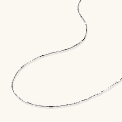 Delicate platinum-plated sterling silver necklace with alternating textured cubic links and smooth chain sections.