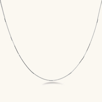 Delicate platinum-plated sterling silver necklace with alternating textured cubic links and smooth chain sections.